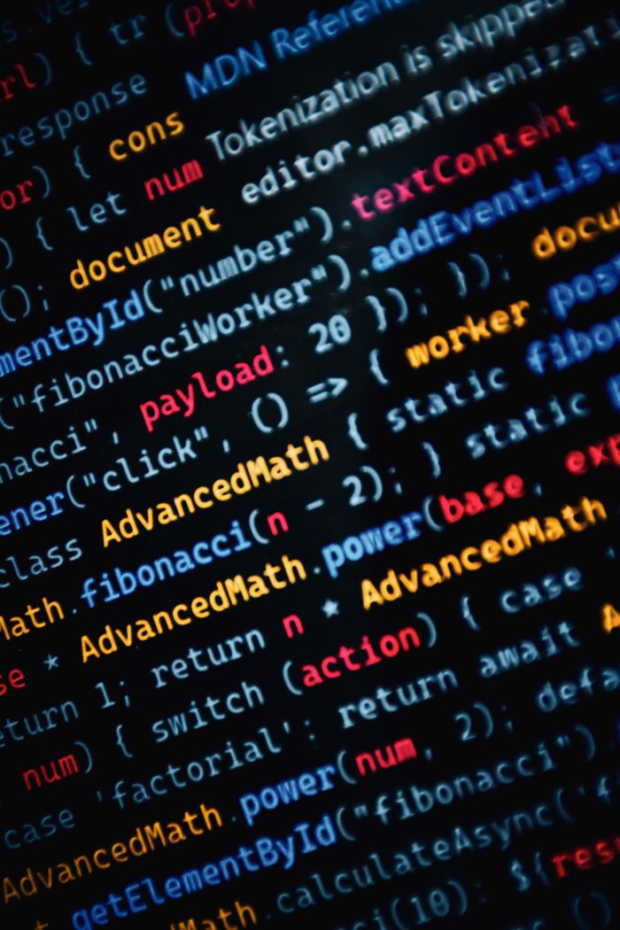 ours-journey Close-up of vibrant JavaScript code displayed on a monitor showcasing web development.